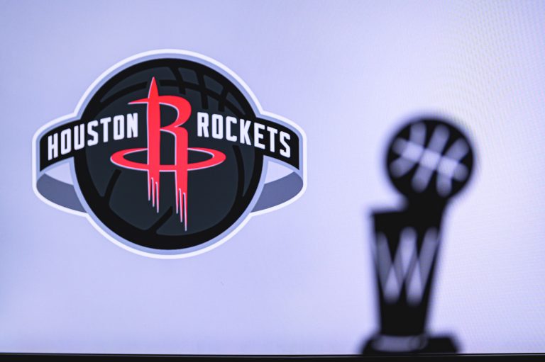 Houston Rockets Basketball club on the white screen. Silhouette of NBA trophy in foreground.