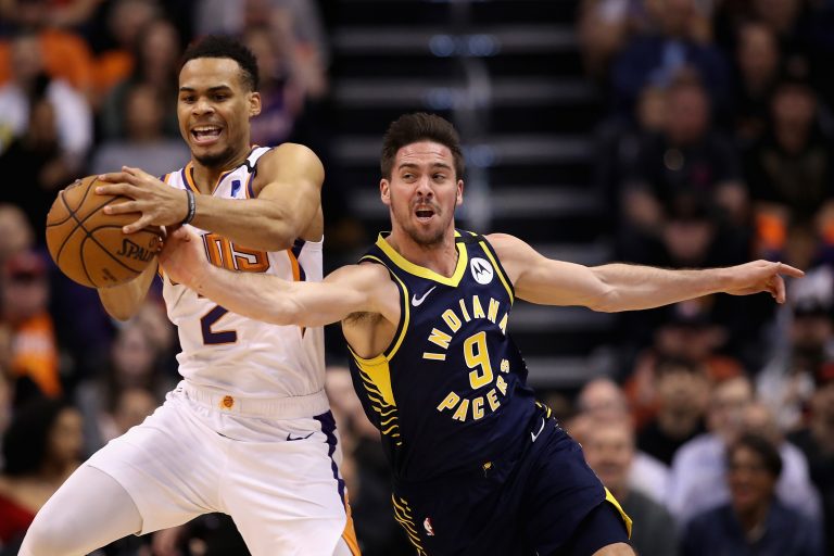 PHOENIX, ARIZONA - JANUARY 22: Elie Okobo #2 of the Phoenix Suns and T.J. McConnell #9 of the Indiana Pacers reach for a loose ball during the first half of the NBA game at Talking Stick Resort Arena on January 22, 2020 in Phoenix, Arizona. NOTE TO USER: User expressly acknowledges and agrees that, by downloading and or using this photograph, user is consenting to the terms and conditions of the Getty Images License Agreement.