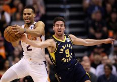 PHOENIX, ARIZONA - JANUARY 22: Elie Okobo #2 of the Phoenix Suns and T.J. McConnell #9 of the Indiana Pacers reach for a loose ball during the first half of the NBA game at Talking Stick Resort Arena on January 22, 2020 in Phoenix, Arizona. NOTE TO USER: User expressly acknowledges and agrees that, by downloading and or using this photograph, user is consenting to the terms and conditions of the Getty Images License Agreement.